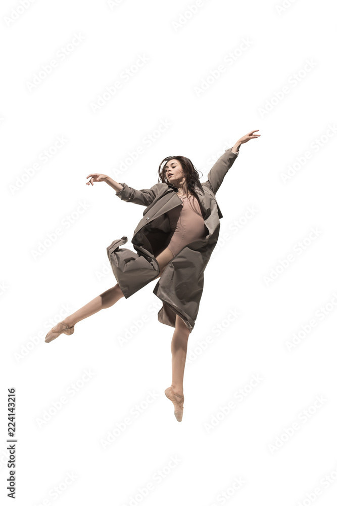 Obraz premium Beautiful slim young female modern jazz contemporary style ballet dancer in silhouette wearing beige long cloak isolated on a white studio background