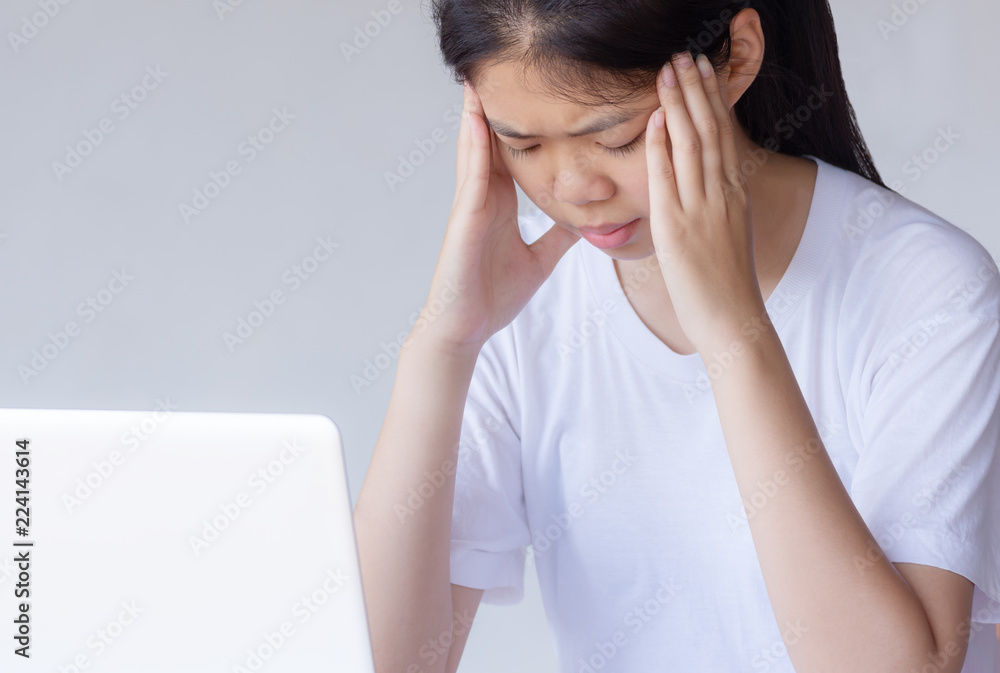 young asian woman tried and headache with laptop young asian woman tried and headache with laptop