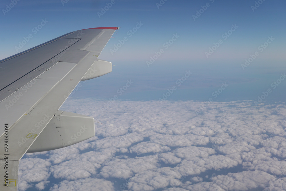 Fototapeta premium Wing blue sky and clouds in the journey