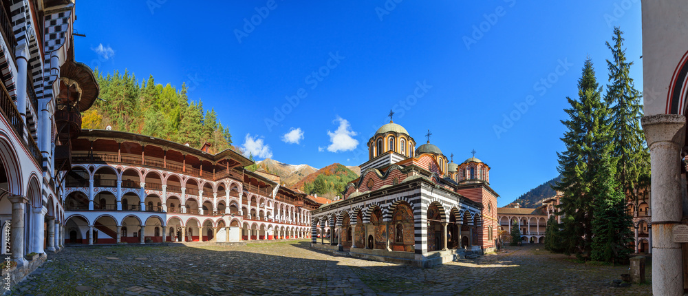 Beautiful panoramic panorama of the Orthodox Rila Monastery, a famous tourist attraction and cultural heritage monument in the Rila Nature Park mountains in Bulgaria - obrazy, fototapety, plakaty 