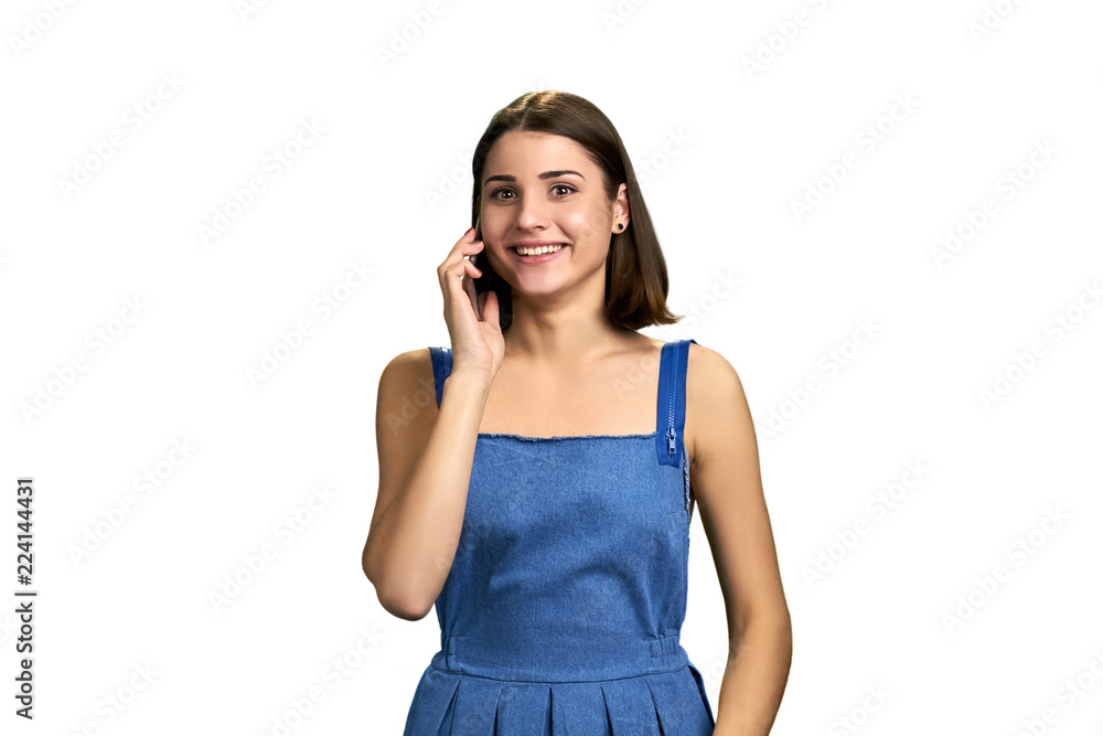 Happy smiling female talking on phone. Joyful short hair young woman speaking on telephone over white background. People, communication, emotions. Happy smiling female talking on phone. Joyful short hair young woman speaking on telephone over white background. People, communication, emotions.
