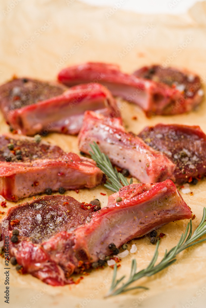 Raw lamb chops on a paper prepared for cooking on a cooking paper