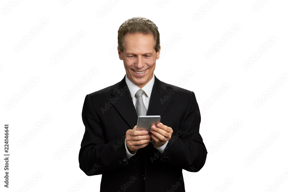 Portrait of cheerful businessman holding smartphone. Mature manager looking at smartphone and smiling, isolated on white background. Portrait of cheerful businessman holding smartphone. Mature manager looking at smartphone and smiling, isolated on white background.