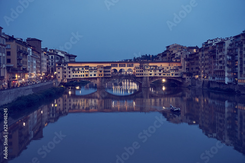 Famous bridge "Ponte Vecchio" in Florence in Italy at night / Illuminated bridge with nice reflections in the water © marako85