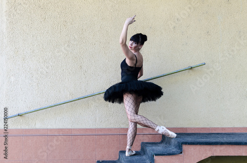 Ballet dancer preforming outside in black tutu photo