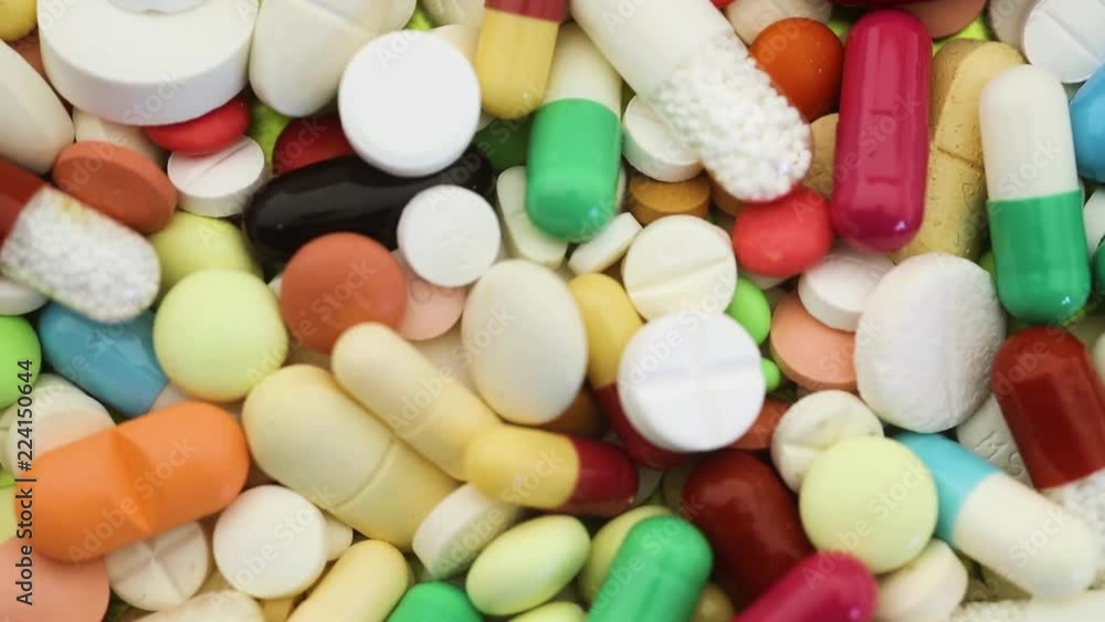Seamless closeup loop of various pills spinning