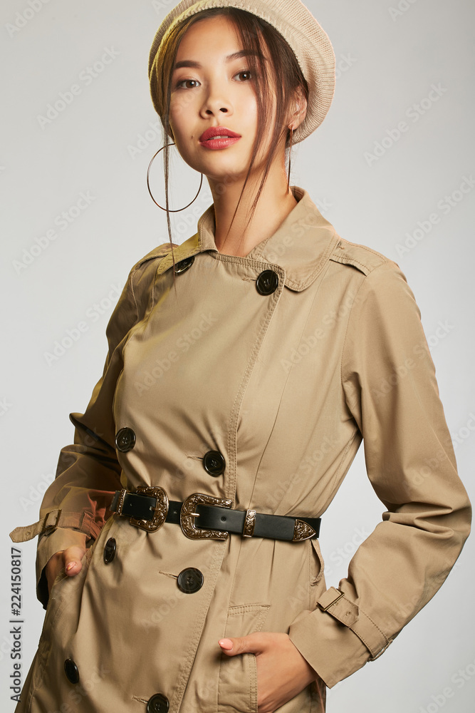 beige trench coat, fastened 