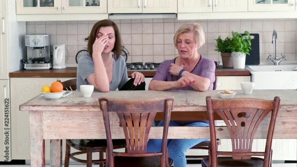 Mother and her adult daughter fighting in the kitchen
Mother and her adult daughter fighting in the kitchen
