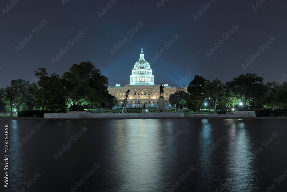 Washington DC. The United States Capitol building with the dome lit up at night. 