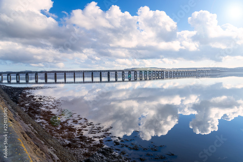 View of Railway Bridge Across a River on a Sunny Winter Afternoon. Lens Flare. Dundee, Scotland photo