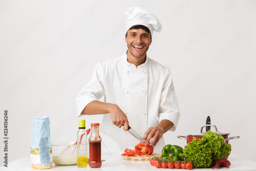 Chef man isolated over white wall background cooking. Chef man isolated over white wall background cooking.