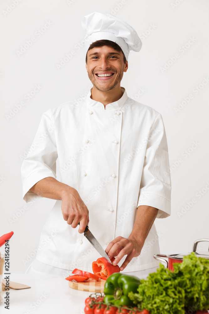Chef man isolated over white wall background cooking. Chef man isolated over white wall background cooking.