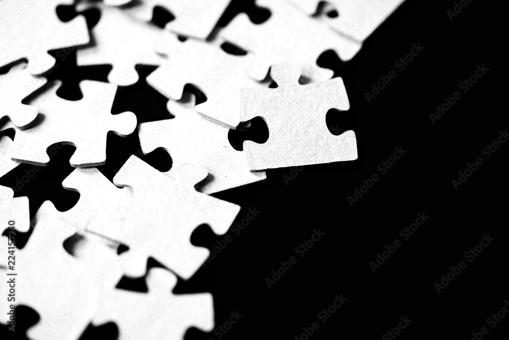 Children's puzzles scattered on a table close up. Black and white Children's puzzles scattered on a table close up. Black and white