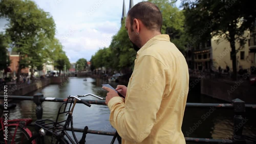 5845_Portrait of A lost young man with smartphone looking for direction in the city 5845_Portrait of A lost young man with smartphone looking for direction in the city
