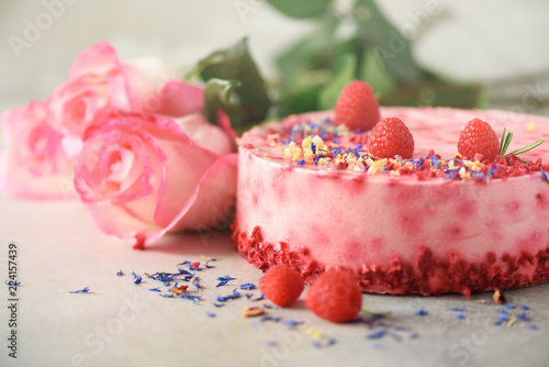 Pink roses and raspberry cake with fresh berries  rosemary  dry flowers on concrete background. Copy space for your text. Birthday party concept