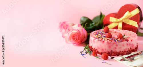 Gift boxes in shape of heart, roses, raspberry cake with fresh berries, rosemary and dry flowers on pink background. Banner, copy space. Valentine's Day concept. Present with love