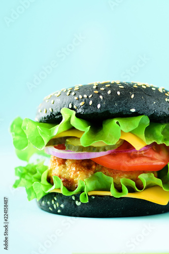 Homemade cheese burger or hamburger on blue background with copy space. Fast food for breakfast, lunch.