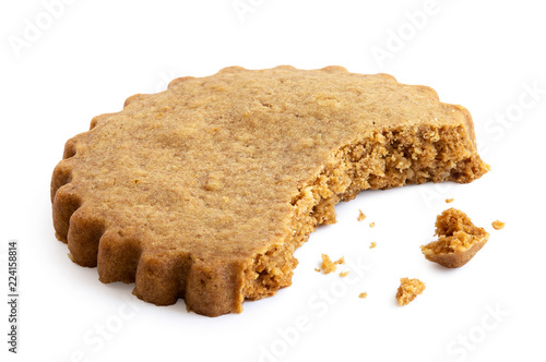 Partially eaten round gingerbread biscuit isolated on white. Serrated edge. photo