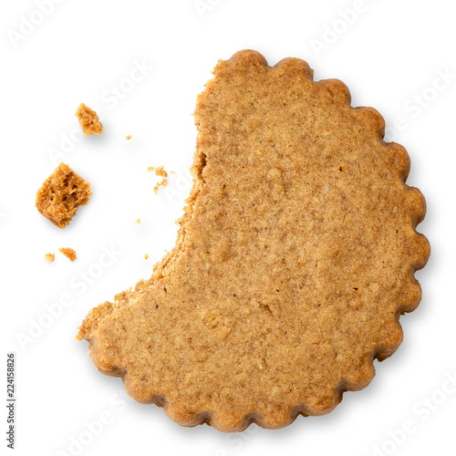 Partially eaten round gingerbread biscuit isolated on white from above. Serrated edge. photo