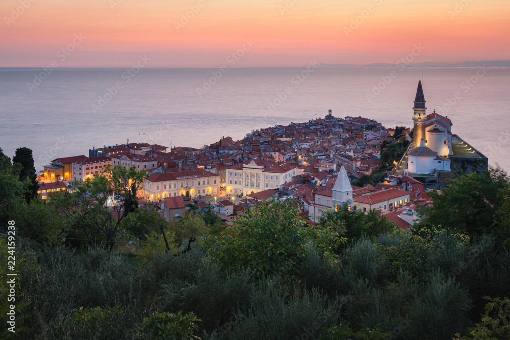 Romantic colorful sunset over picturesque old town Piran, Slovenia. Scenic panoramic view.