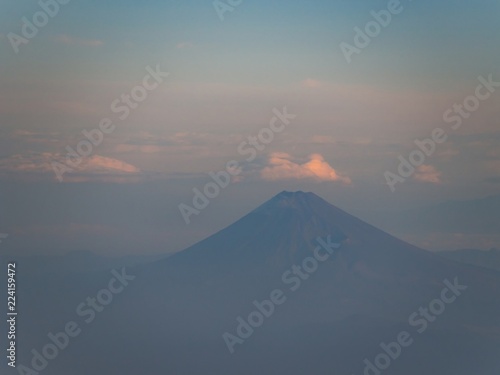 Mount Fuji in summer with cloudy sky and morning light. Aerial view from an airplane. - Max zoom version