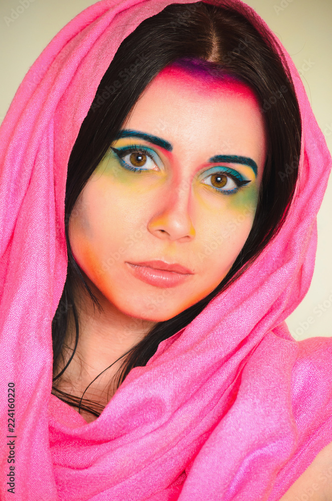 Young caucasian woman with colorful makeup and pink head shawl Young caucasian woman with colorful makeup and pink head shawl