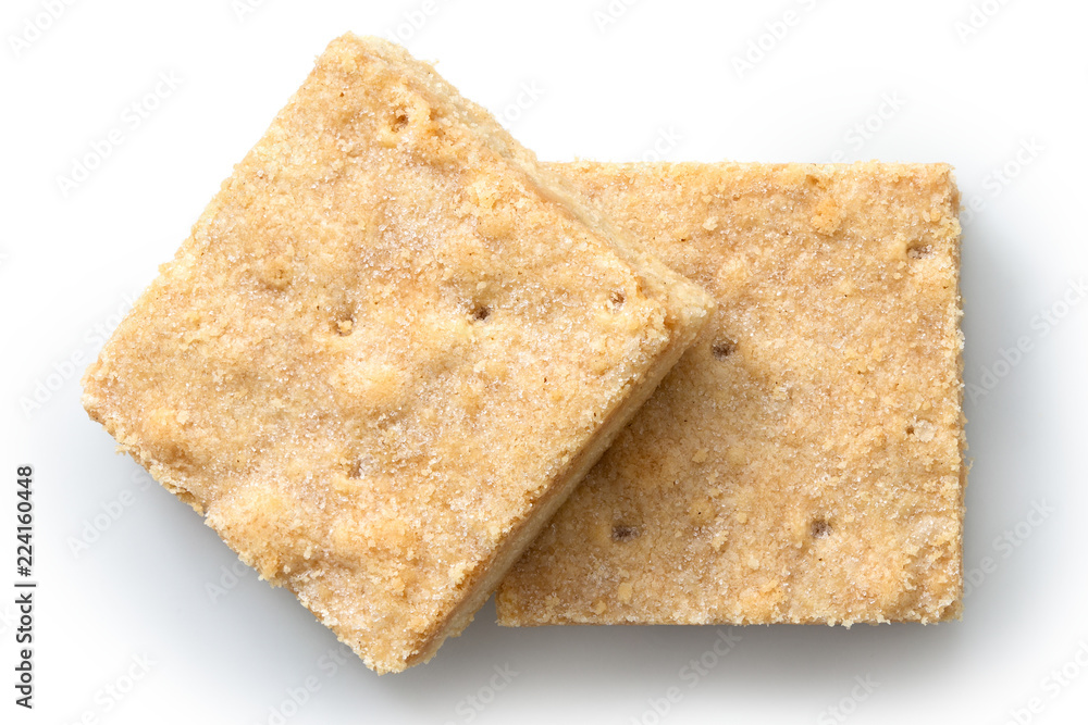 Fototapeta premium Two classic homemade square shortbread biscuits isolated on white from above.