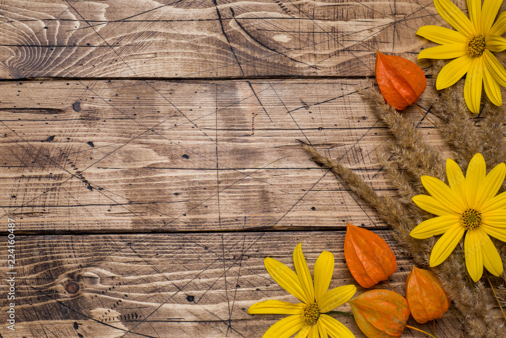 Autumn flowers on wooden background with copy space.
