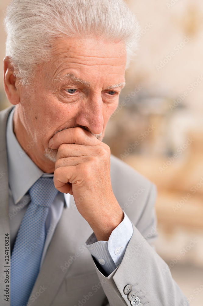 Portrait of elderly business man thinking at home Portrait of elderly business man thinking at home