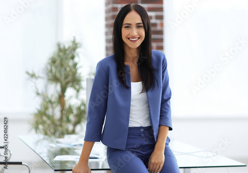 Portrait of successful businesswoman standing at her office. photo
