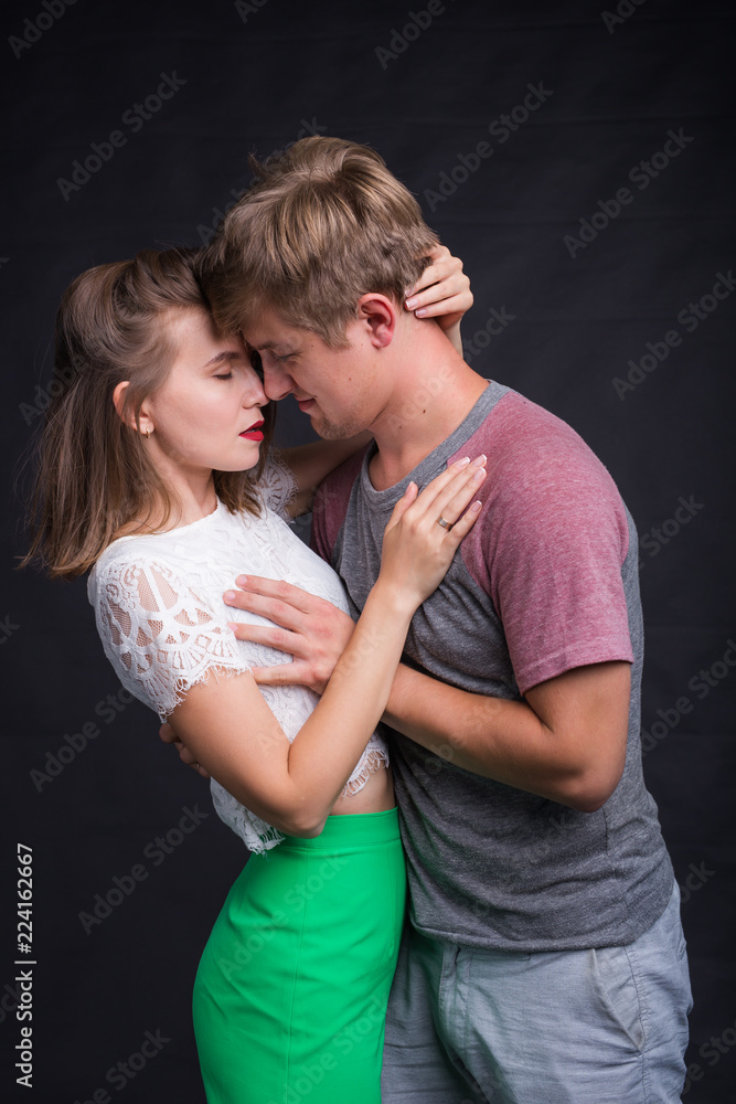 Lovers kissing each other on black background Lovers kissing each other on black background