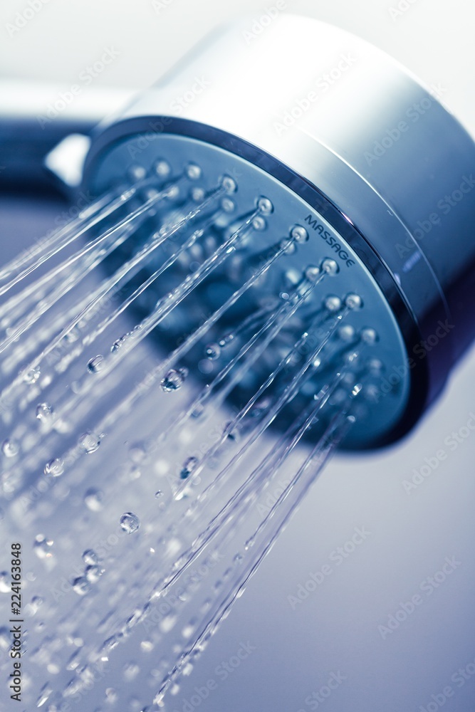 Shower Head with Water Stream on Blue Background Shower Head with Water Stream on Blue Background