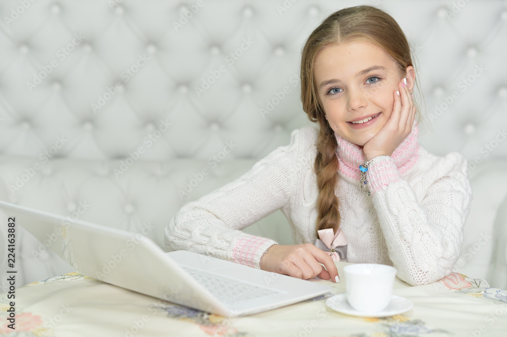 cute beautiful girl using laptop at home