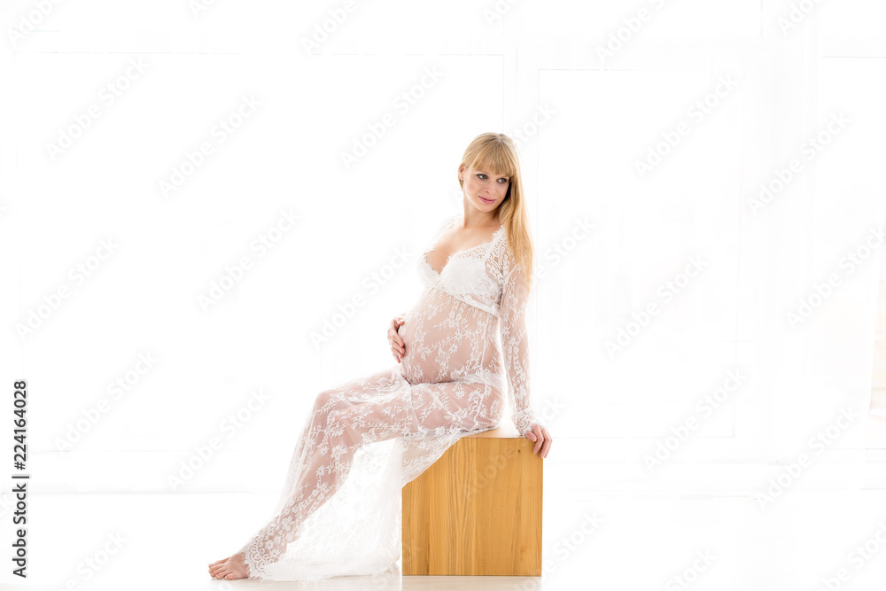 pregnant girl. pregnant in a white negligee. blonde. the girl with the belly in white pregnant girl. pregnant in a white negligee. blonde. the girl with the belly in white