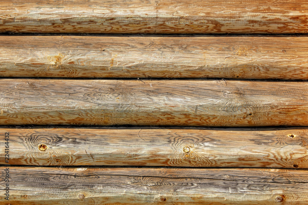 Wall with log house in the house as a background Wall with log house in the house as a background