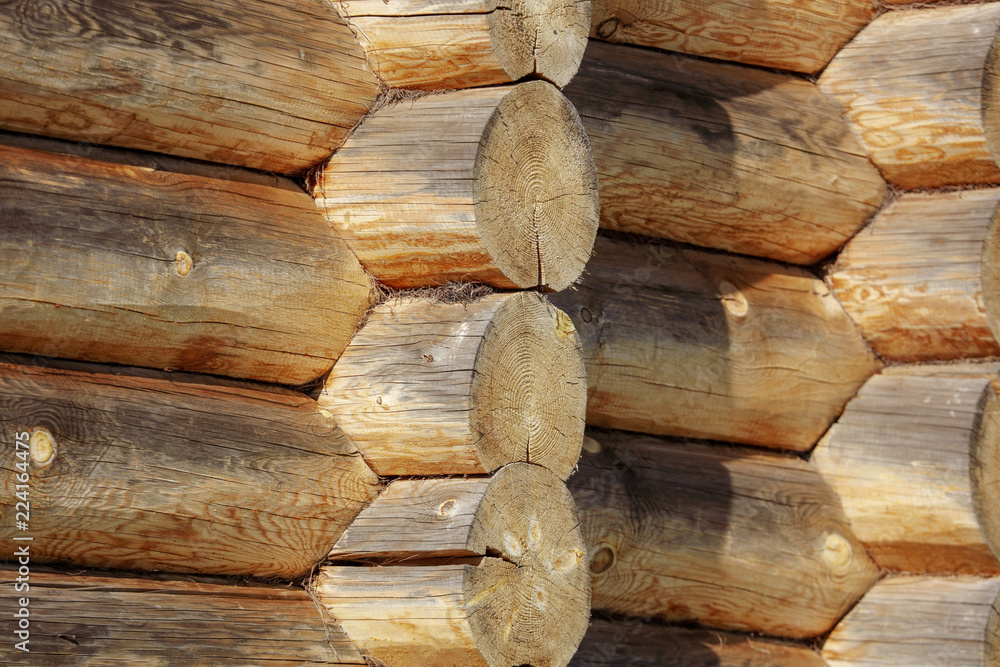 Wall with log house in the house as a background Wall with log house in the house as a background