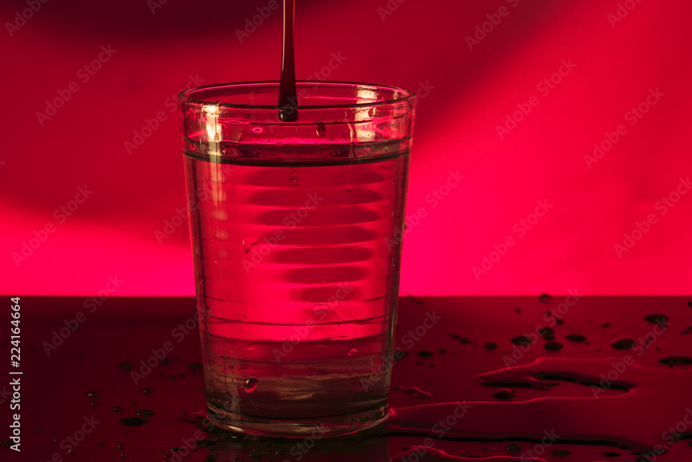 Honey drop inside water glass Honey drop inside water glass