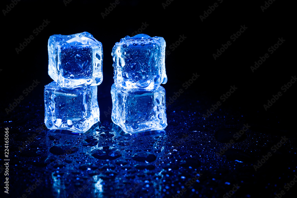 Blue ice cubes reflection on black table background. Blue ice cubes reflection on black table background.