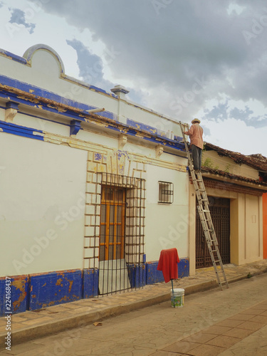 Worker on a ladder in San Cristobal de las casas, Mexico photo