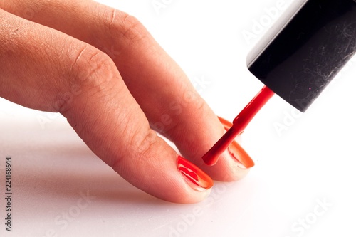 painting a nail with a colourful nail polish