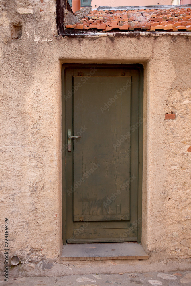 external old wooden door and a plaster waal