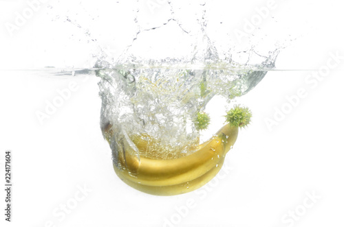 banana and chestnuts fall into the water.  fruit in water. Aqua shooting.  food. yellow bananas