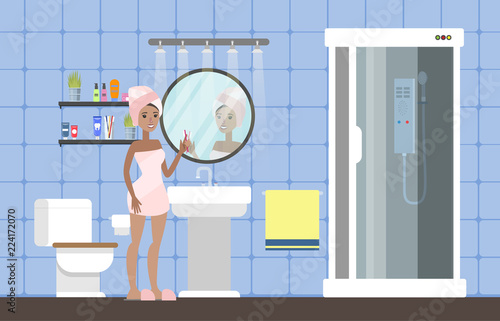 Woman after a shower standing in bathroom