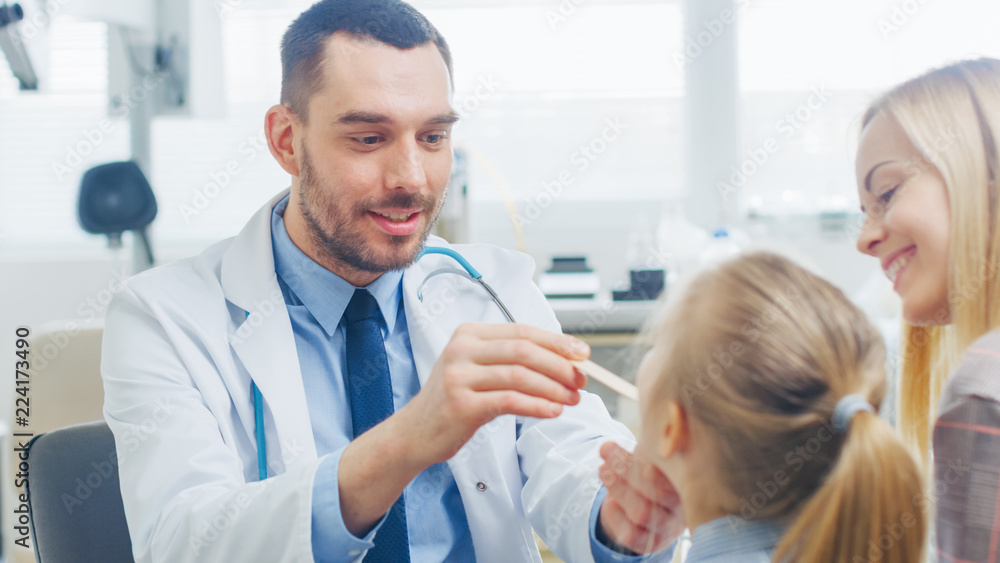 Friendly Doctor Checks up Little Girl's Sore Throat, Mother is Present for Support. Modern Medical Health Care, Friendly Pediatrician and Bright Office. Friendly Doctor Checks up Little Girl's Sore Throat, Mother is Present for Support. Modern Medical Health Care, Friendly Pediatrician and Bright Office.