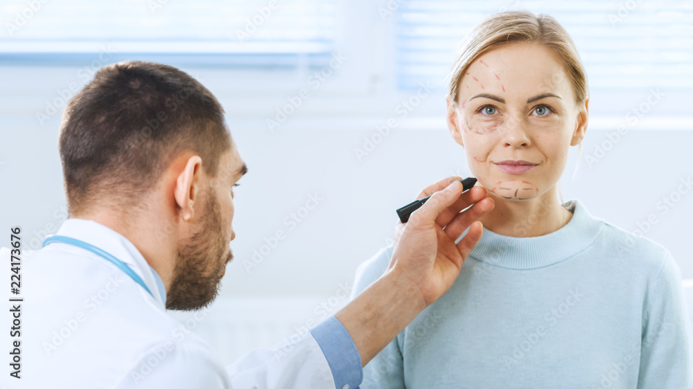 Over the Shoulder Shot of a Plastic / Cosmetic Surgeon Draws Lines on a Face of a Beautiful Female model for the Facelift Operation. Over the Shoulder Shot of a Plastic / Cosmetic Surgeon Draws Lines on a Face of a Beautiful Female model for the Facelift Operation.