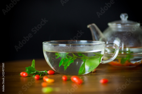 hot tea from ripe red goji berries in a glass teapot