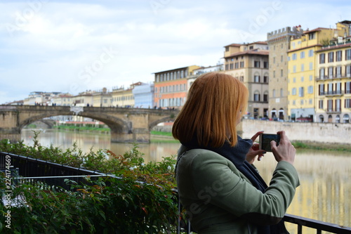 Girl taking pictures of the sights of Florence