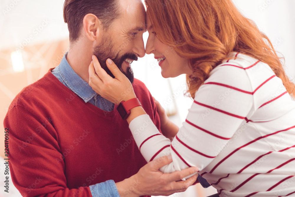 Naklejka premium Forever together. Delighted mid aged couple expressing love while resting with her husband