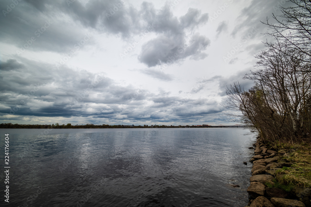Fototapeta premium lake shore with grass and trees in spring
