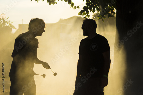 musicisti parlano tra loro in mezzo al fumo di un concerto all'ora del tramonto photo